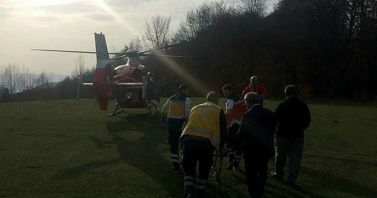 Devrilen traktörün altında kalan şahıs ambulans helikopterle hastaneye kaldırıldı