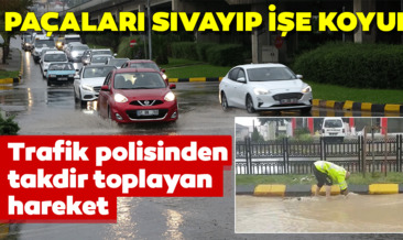Sağanak yağmur sürücülere zor anlar yaşattı! Trabzon’da tıkanan mazgalı trafik polisi böyle açtı