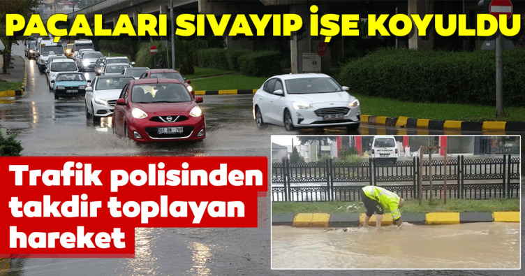 Sağanak yağmur sürücülere zor anlar yaşattı! Trabzon’da tıkanan mazgalı trafik polisi böyle açtı