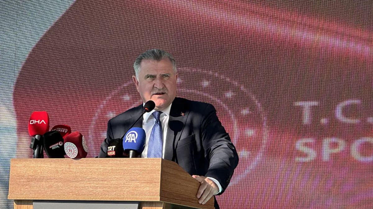 Gençlik ve Spor Bakanı Osman Aşkın Bak, milli bisikletçi Ramazan Yılmaz'ı tebrik ediyor.