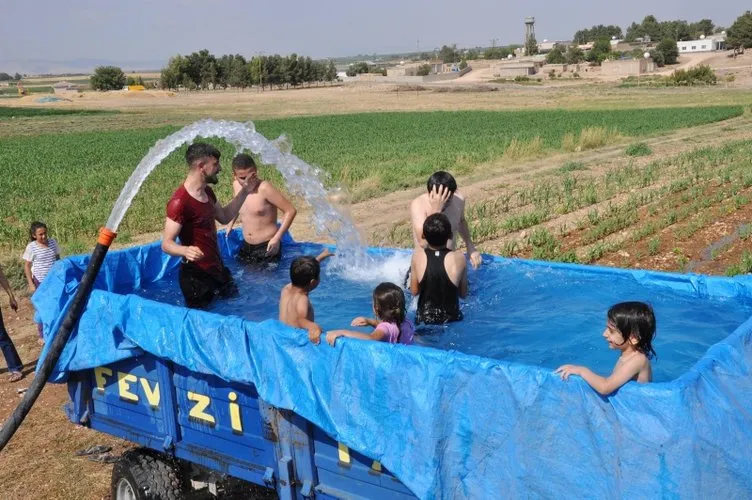 Sıcaktan bunalan çiftçiler traktör römorkunu havuza çevirdi