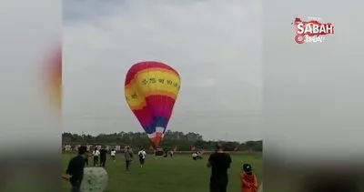 Çinli çalışan sıcak hava balonunun sepetine asılı kalıp metrelerce yüksekten yere çakıldı