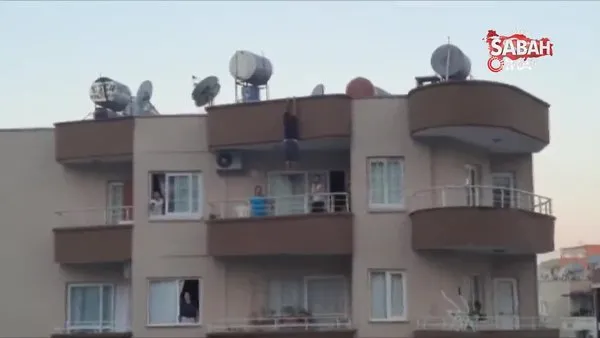Mersin'de yürekleri ağza getiren görüntü. Asılı kaldığı çatıdan, 5. katın balkonuna düşerek kurtuldu | Video