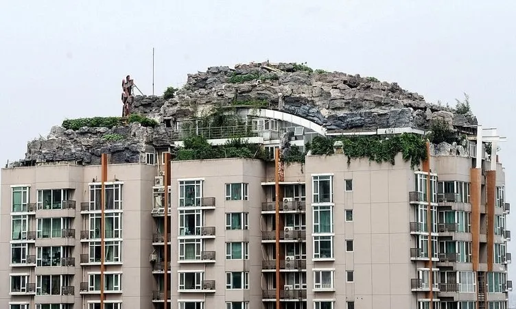 Binanın çatısına dağ inşa etti
